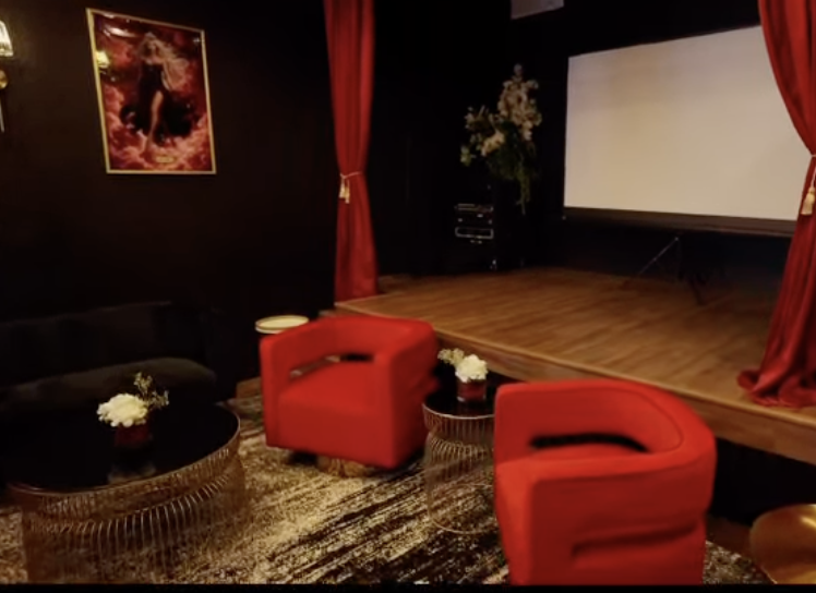 Performance stage with red velvet curtains at Babe Coffee Lounge