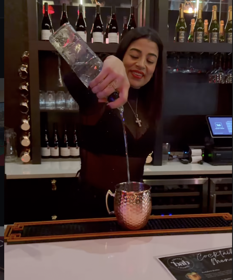 Bartender crafting a Moscow mule at Babe Coffee Lounge