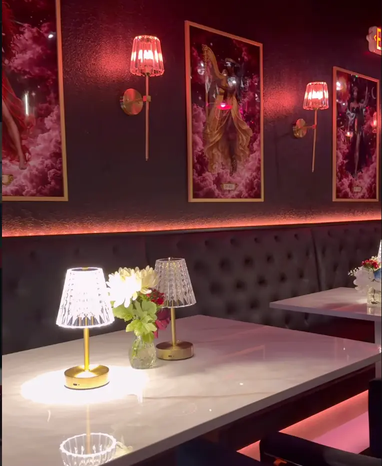 Velvet booth seating along the wall of the Babe Coffee Lounge private event space, set for a seated gathering.