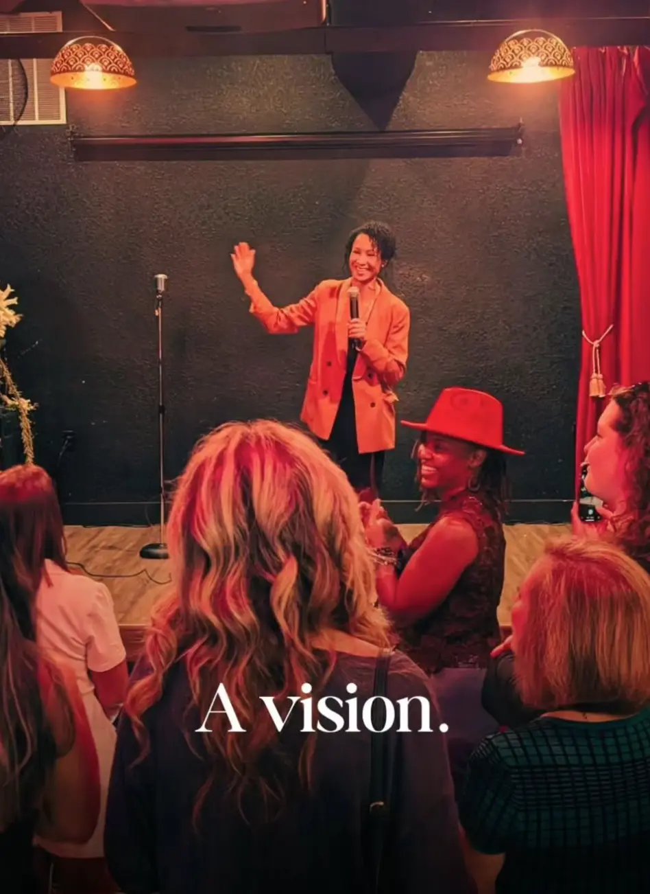 A speaker waves from the Babe Coffee Lounge stage to a cheering audience at a private corporate event.